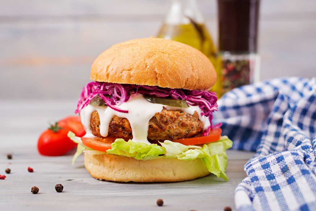 Juicy beef burger with melted cheese, lettuce, tomato, onions, and pickles on a sesame seed bun homemade Sloppy Joes - Allrecipeworld